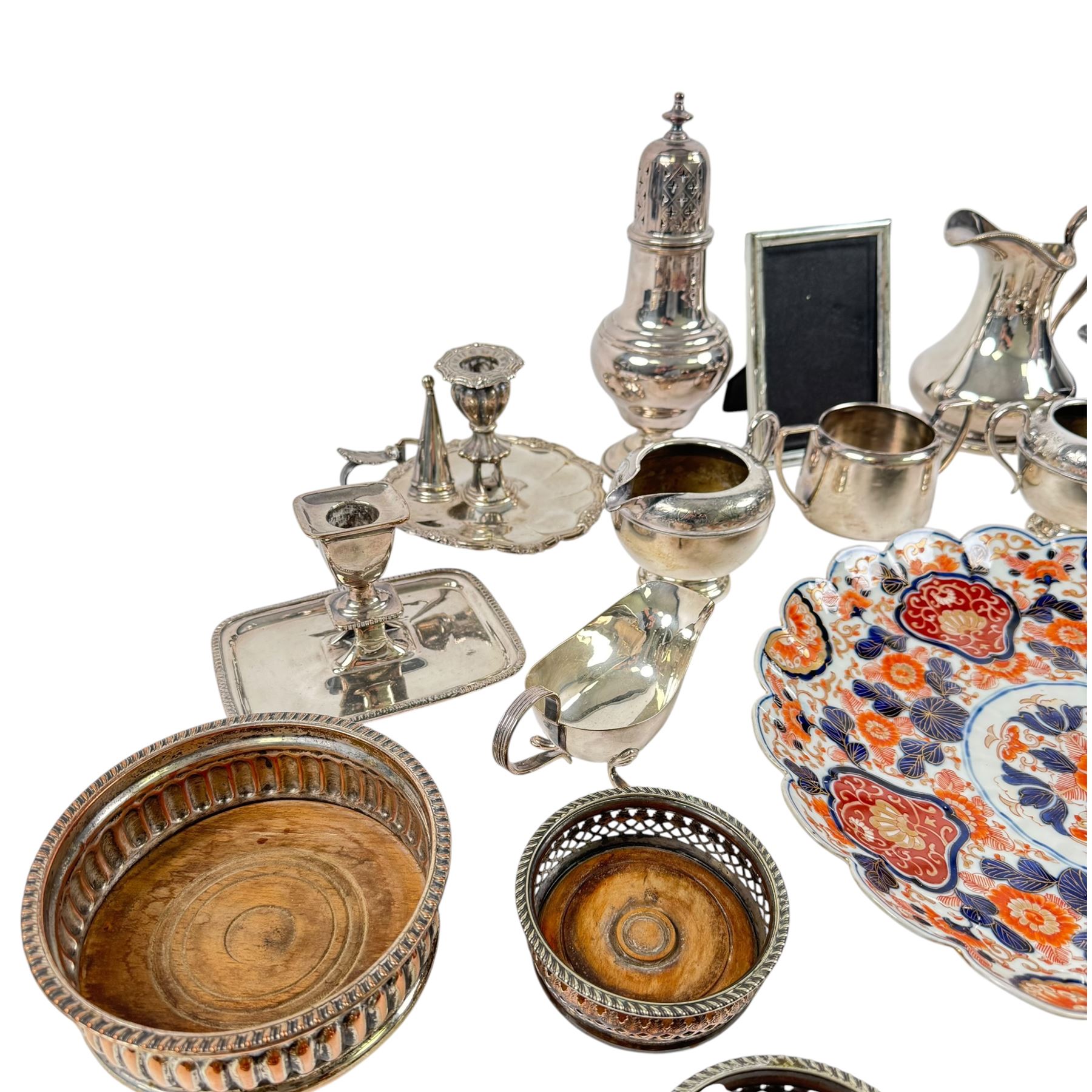 Silver plated items, including thee pairs of bottle coasters, sugar caster, Elkington jug, chamberstick etc and a Japanese Imari scalloped charger