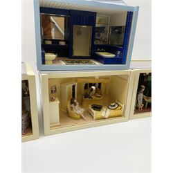 Four small dioramas, comprising a cottage sitting room, with elderly couple and dog and cat, country kitchen with cook and ginger cat, girls bedroom, and bathroom, each H13.5cm L21cm D13.5cm.