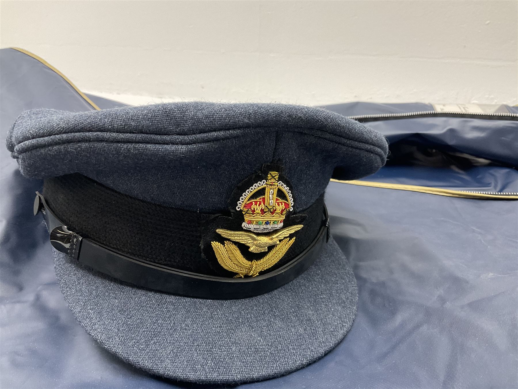 RAF Flight Lieutenant's uniform with peaked cap and WW2 ribbon bar; WW2 gas mask in blue canvas bag dated 1942; flying helmet date 1984; and British Army Major's uniform with Staybrite buttons and peaked cap