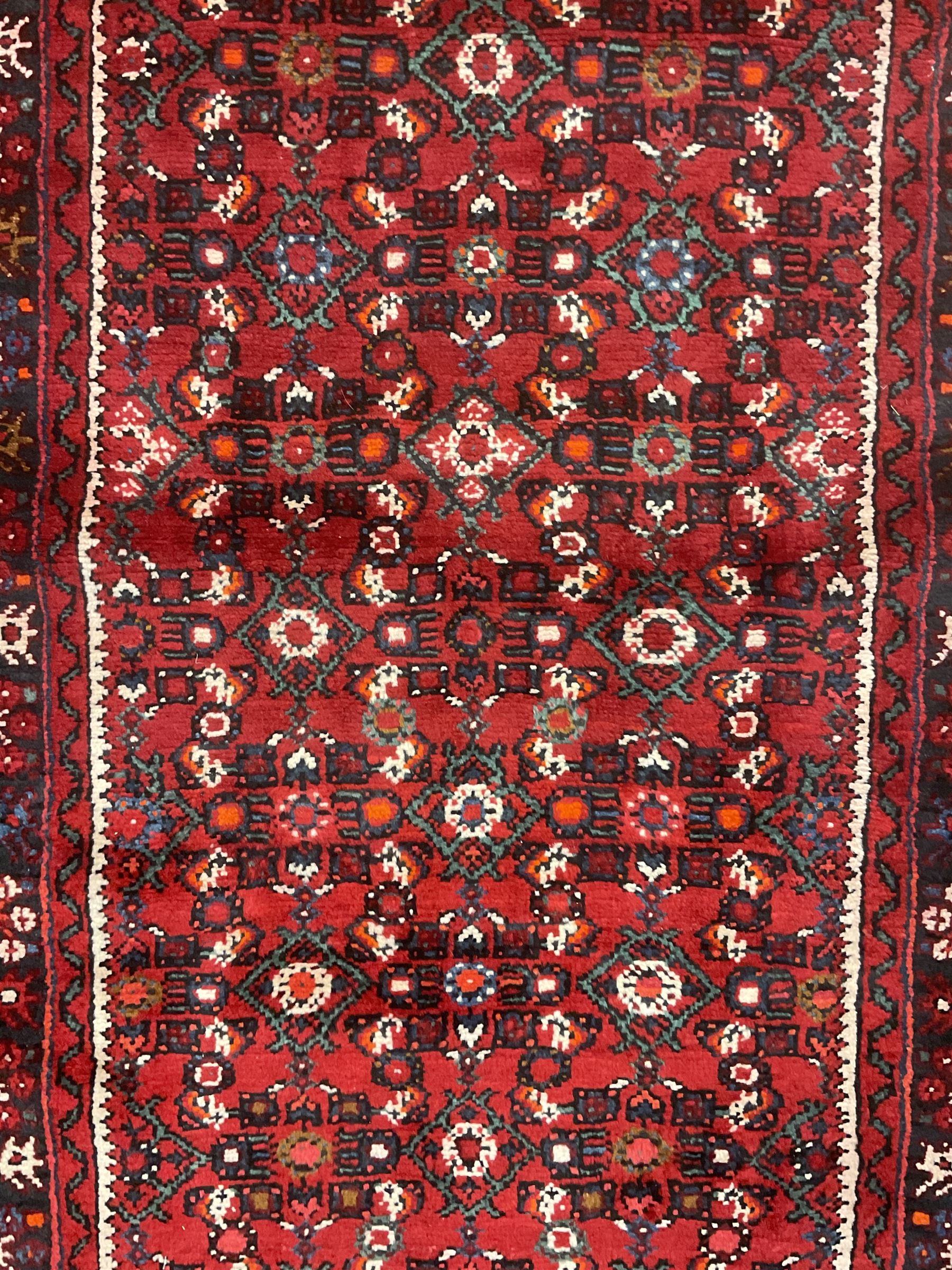 North West Persian Malayer runner, red ground field decorated with Herati motifs, guarded border decorated with trailing flowerhead band 