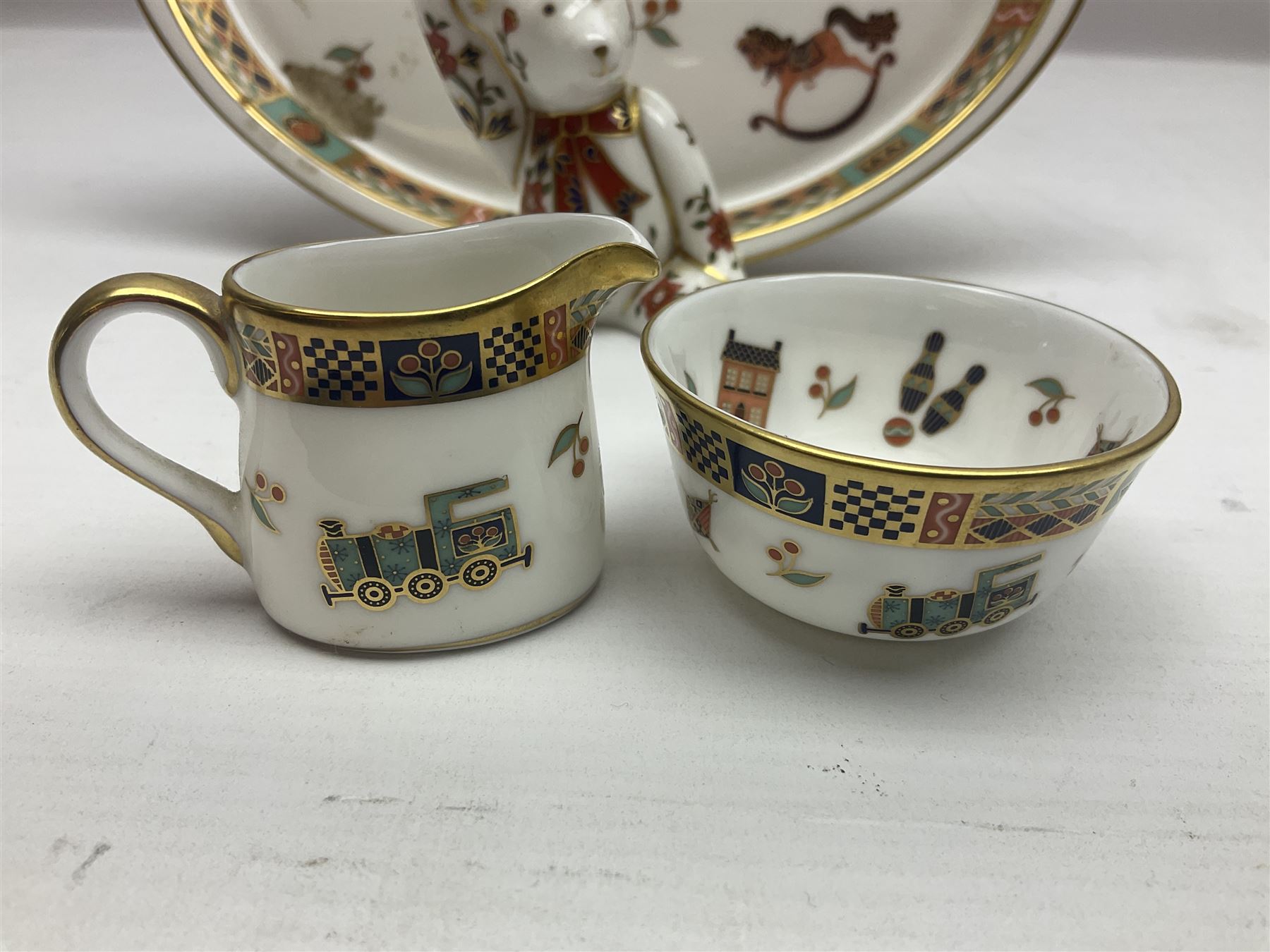 Royal Crown Derby Treasures of Childhood cabaret set, comprising tray, milk jug, sucrier, teacup and saucer, together with two Royal Crown Derby Treasures of Childhood paperweights Fleur and Ragdoll Sailor and Teddy bear paperweight, all paperweights are without stoppers