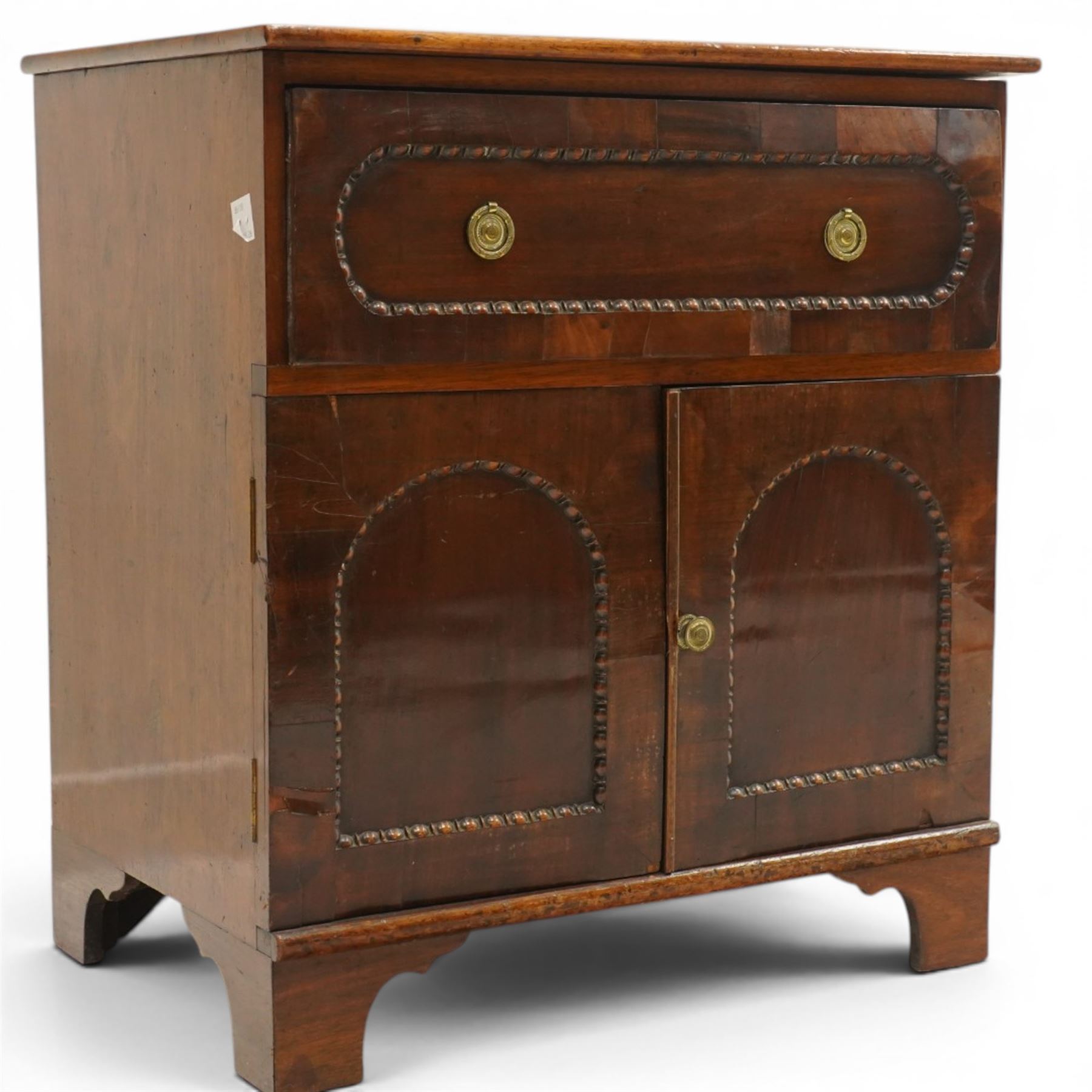 George III mahogany converted commode cabinet, rectangular top over single drawer with egg-and-dart moulding, over two arched panelled cupboard doors, on bracket feet
