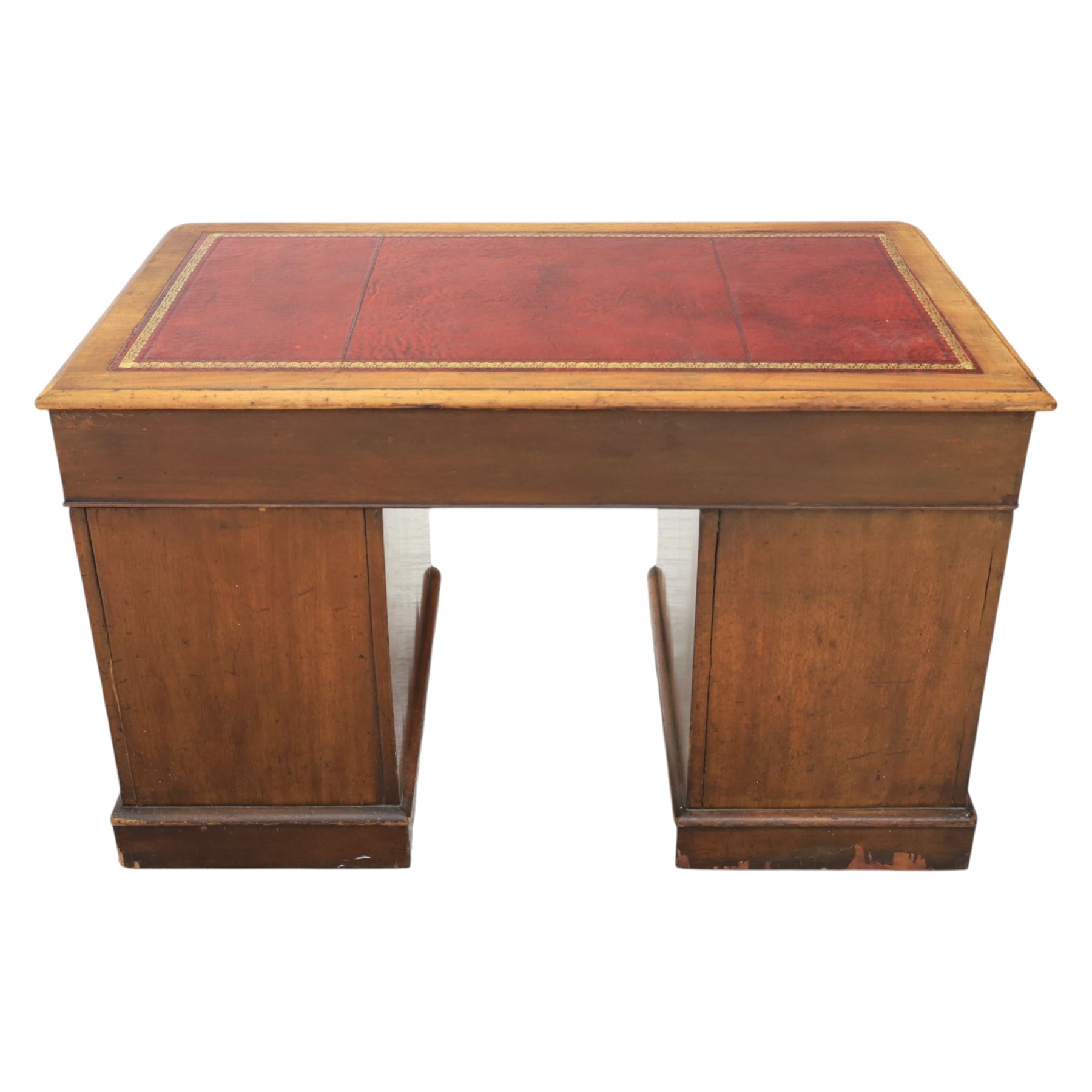 Victorian mahogany writing desk, featuring inset tooled red leather top, raised on two pedestals, nine drawers with figured veneer fronts