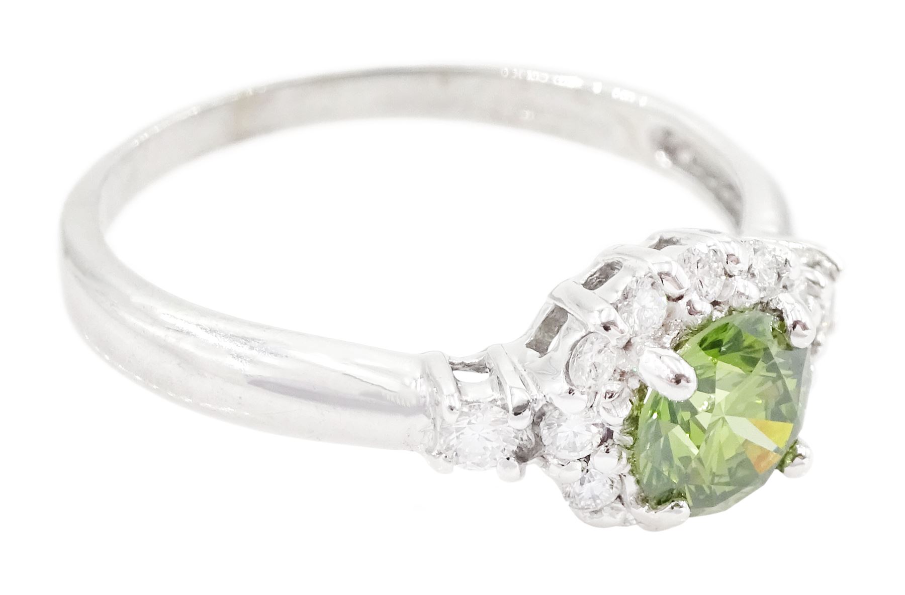 18ct white gold diamond cluster ring, the principal round brilliant cut fancy green diamond of approx 0.65 carat, surrounded by round brilliant cut white diamonds and diamond set shoulders, Birmingham 2007, total white diamond approx 0.20 carat