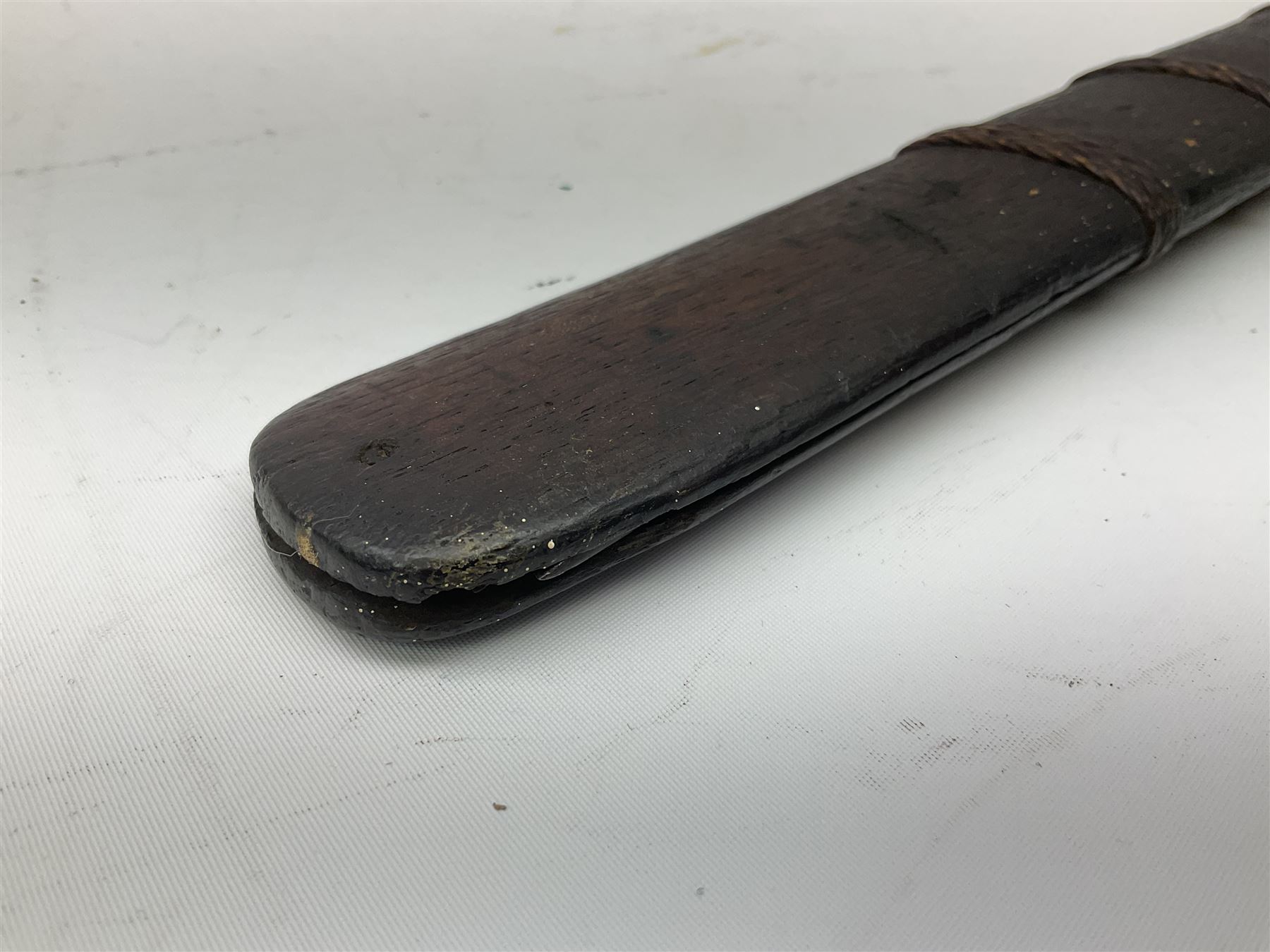 Burmese Dha type sword with 52cm plain steel slightly curving blade and plaited cane bound grip; in wooden scabbard with plaited cane bands L76.5cm overall
