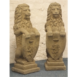 Pair stone effect seated lions, holding crested shield, stepped plinth base, H81cm  