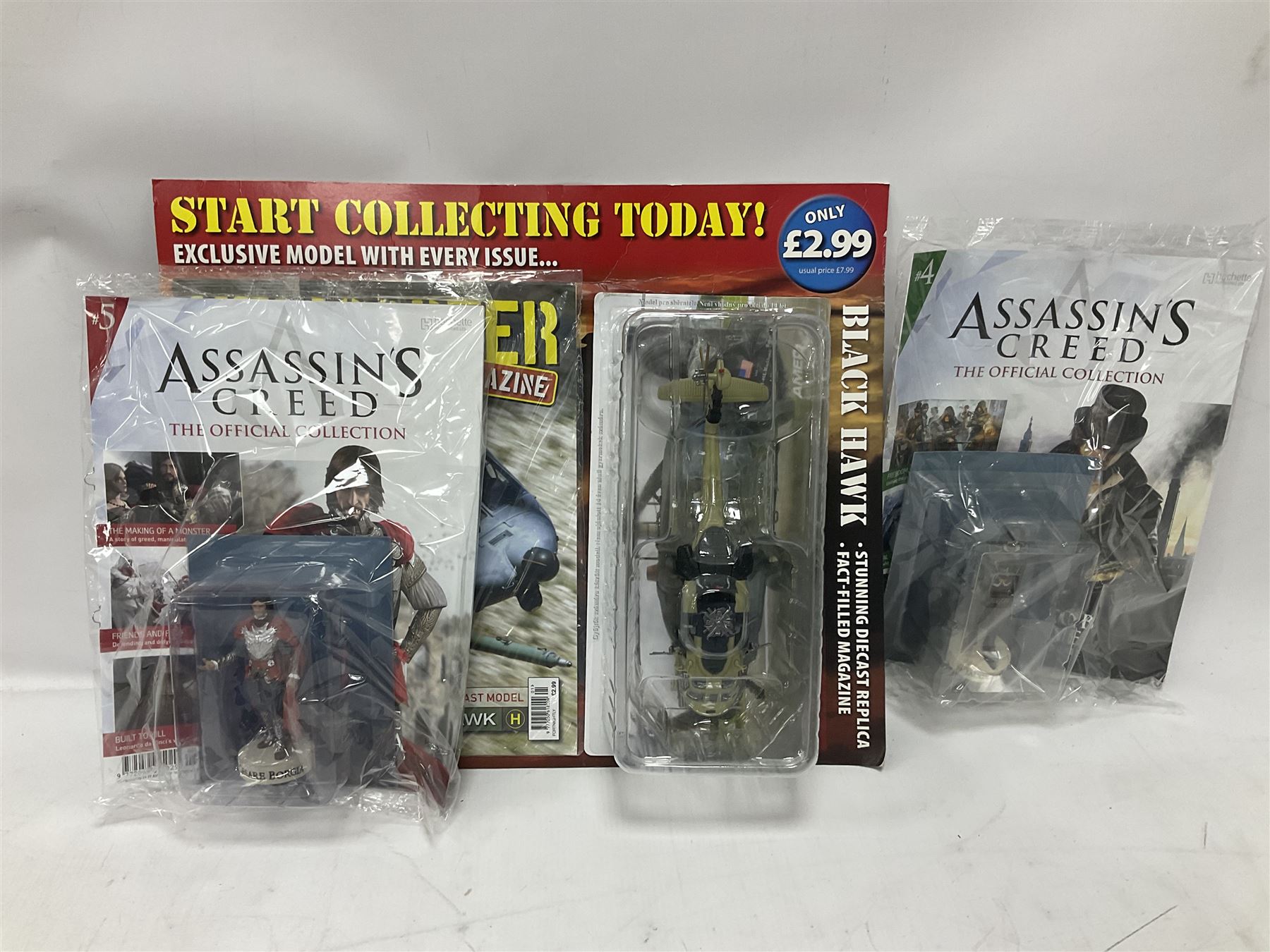 Fifteen Amer Czechoslovakia periodical issued metal models of helicopters each in unopened original packaging with copy of 'Helicopter Magazine'; together with seven unopened Hachette 'Assassin's Creed' periodical figures with magazines (22)