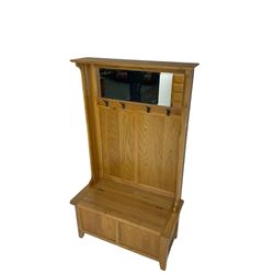 Oak mirror-back hall bench, projecting cornice, rectangular bevelled plate over four coat hooks, hinged box seat compartment with panelled front, on square tapering feet