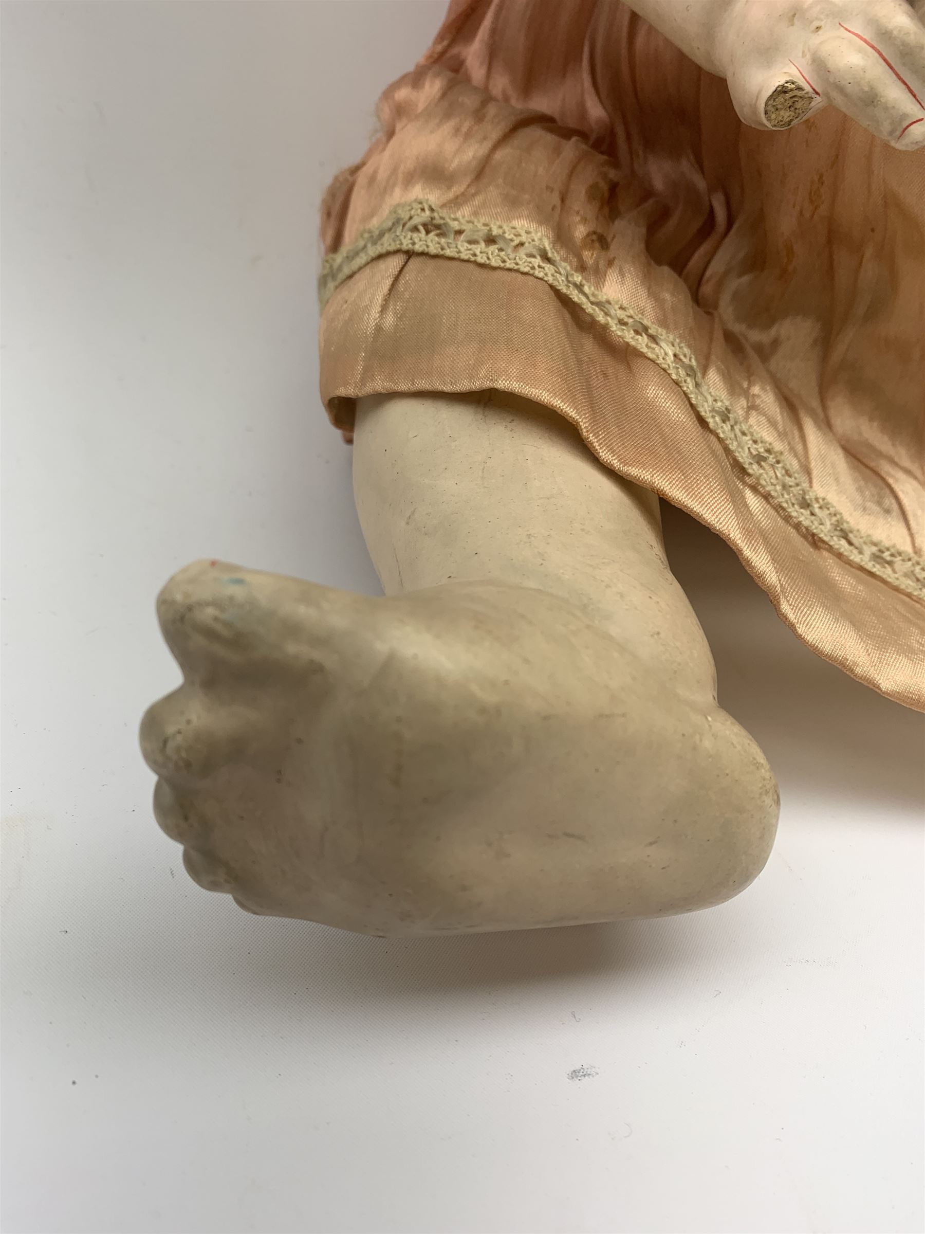 German bisque head doll with applied hair, sleeping eyes and open mouth with teeth and fixed tongue, on composition body with jointed limbs, marked 'P.M. 914 Germany 14' H65cm