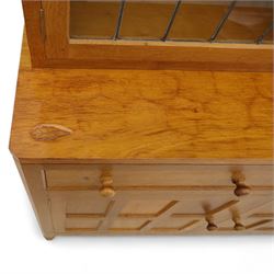 David 'Oakleafman' Langstaff - oak three drawer dresser, the scalloped cornice above a back with central open shelves flanked by two glazed and leaded cupboard doors opening to glass shelves, upon a base with adzed top carved with signature leaf, three drawers and three panelled cupboard doors with turned handles, upon octagonal feet, from the workshop of David Langstaff, Easingwold, Yorkshire