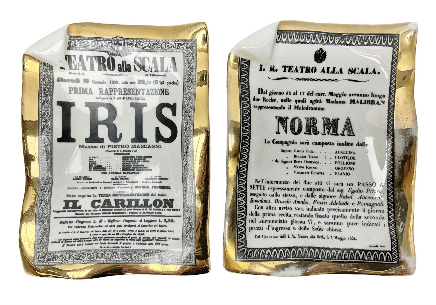 Two Fornasetti rectangular operatic posters ashtrays 'Norma' and 'Iris' decorated with black and white text with a gilt border edge, with printed mark beneath, H16cm