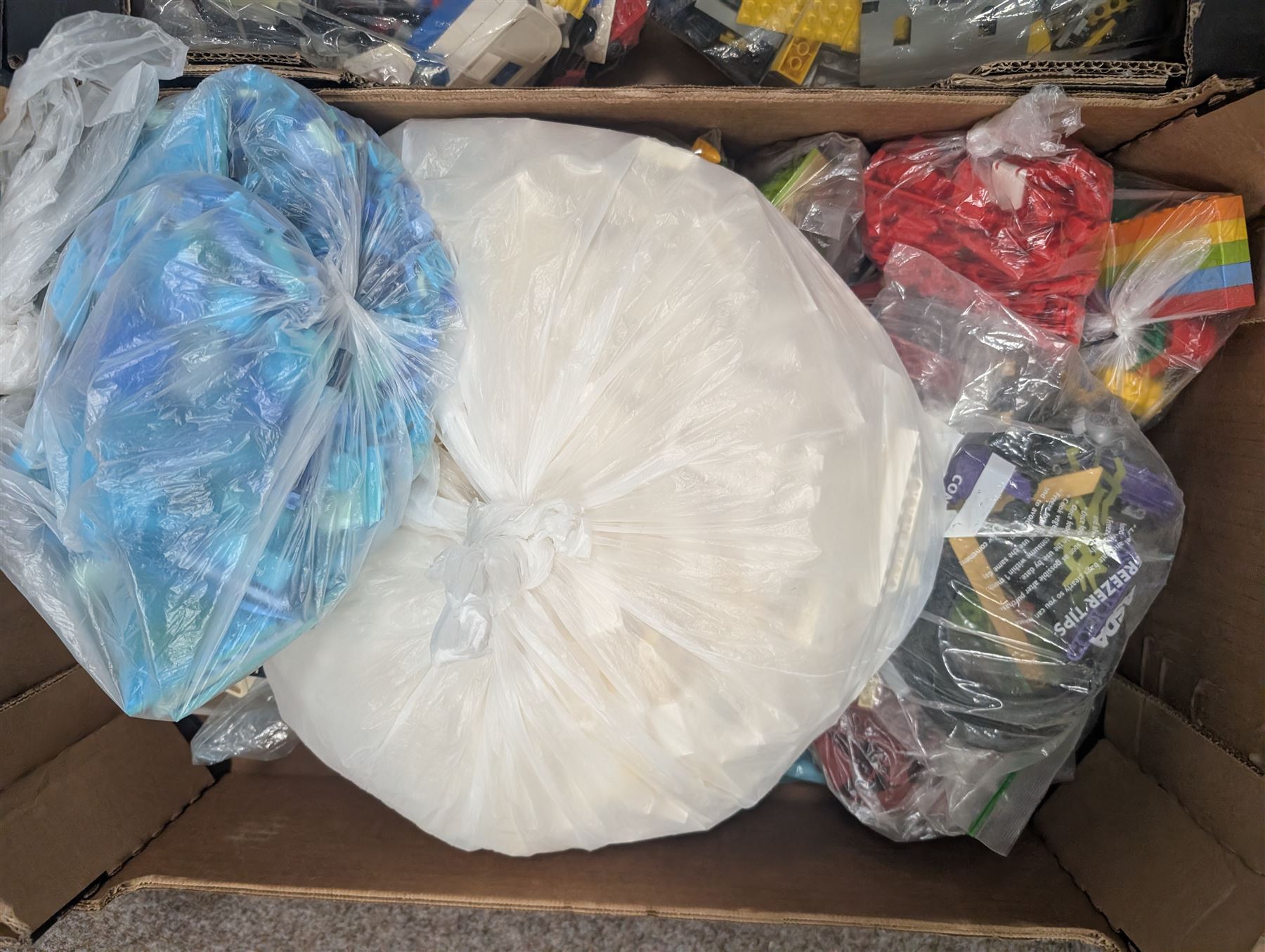 Large collection of loose Lego, including minifigures, together with three Lego ideas books, in five boxes