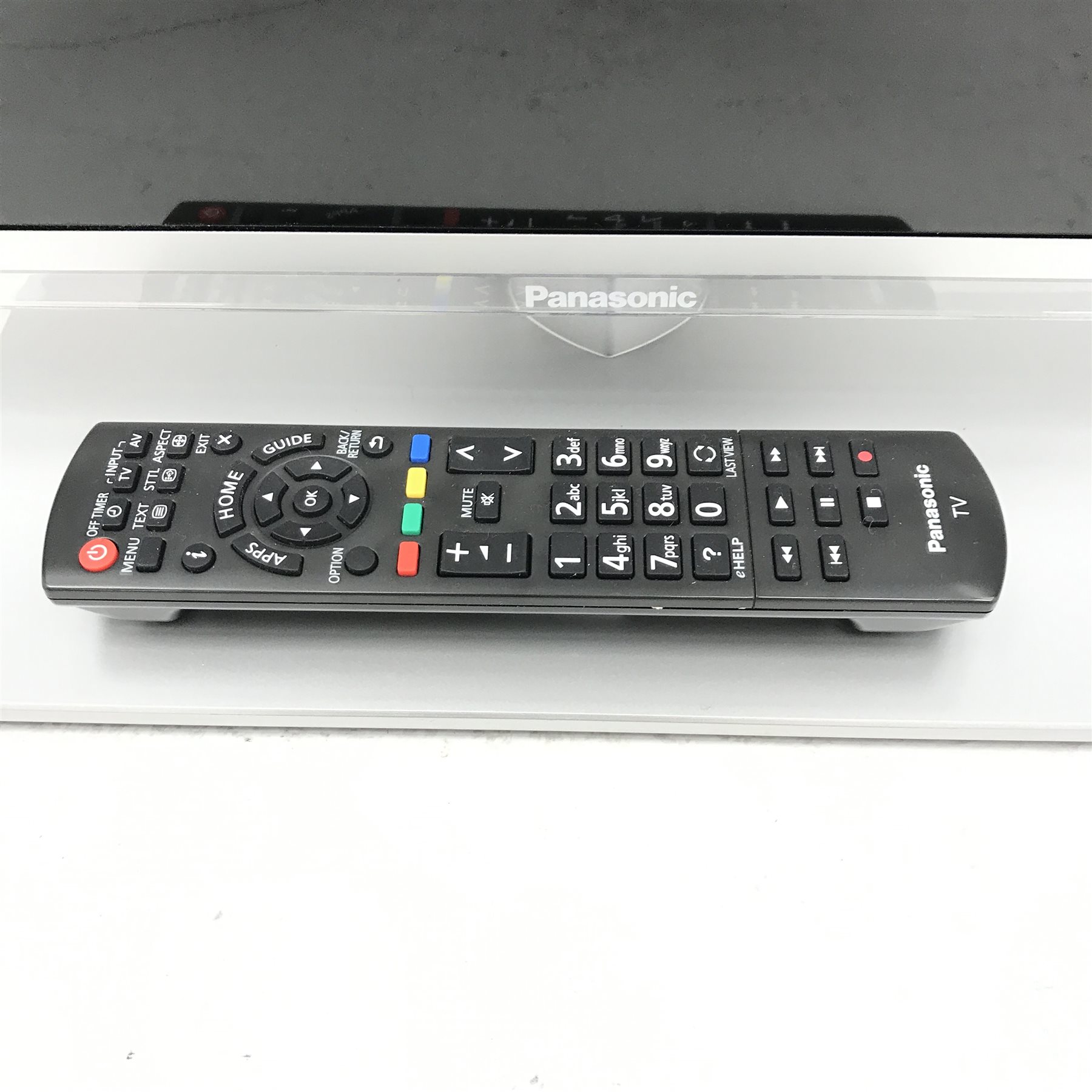 Panasonic TXL32E6B (32”) television and remote control The