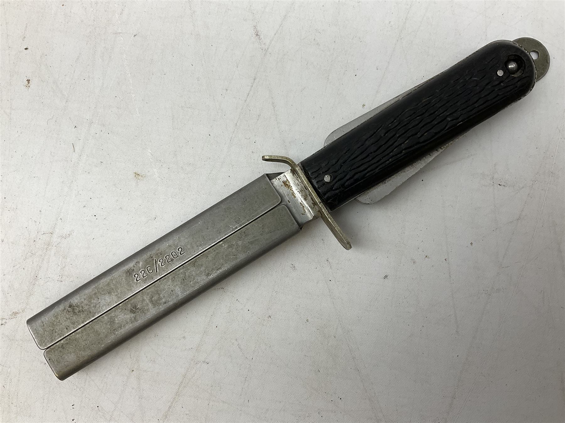 Royal Air Force aircrew survival knife with 10cm Bowie style steel blade marked 'Joseph Rodgers Sheffield England 22C/1996', black grips with twin-sided locking mechanism and lanyard hole to cross-piece; steel scabbard marked 22C/2202 L23cm overall (with photocopies of modern reference material)