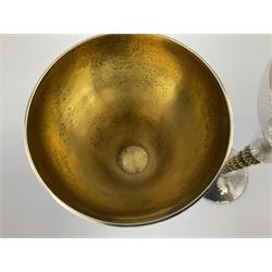 Pair of modern silver goblets by Stuart Devlin, the tapering cylindrical bowls each with spot hammered decoration and gilt interiors, the parcel gilt stems with signature textured detailing and six graduating knops, upon conforming spreading circular foot, hallmarked Stuart Devlin, London 1976, H17.7cm