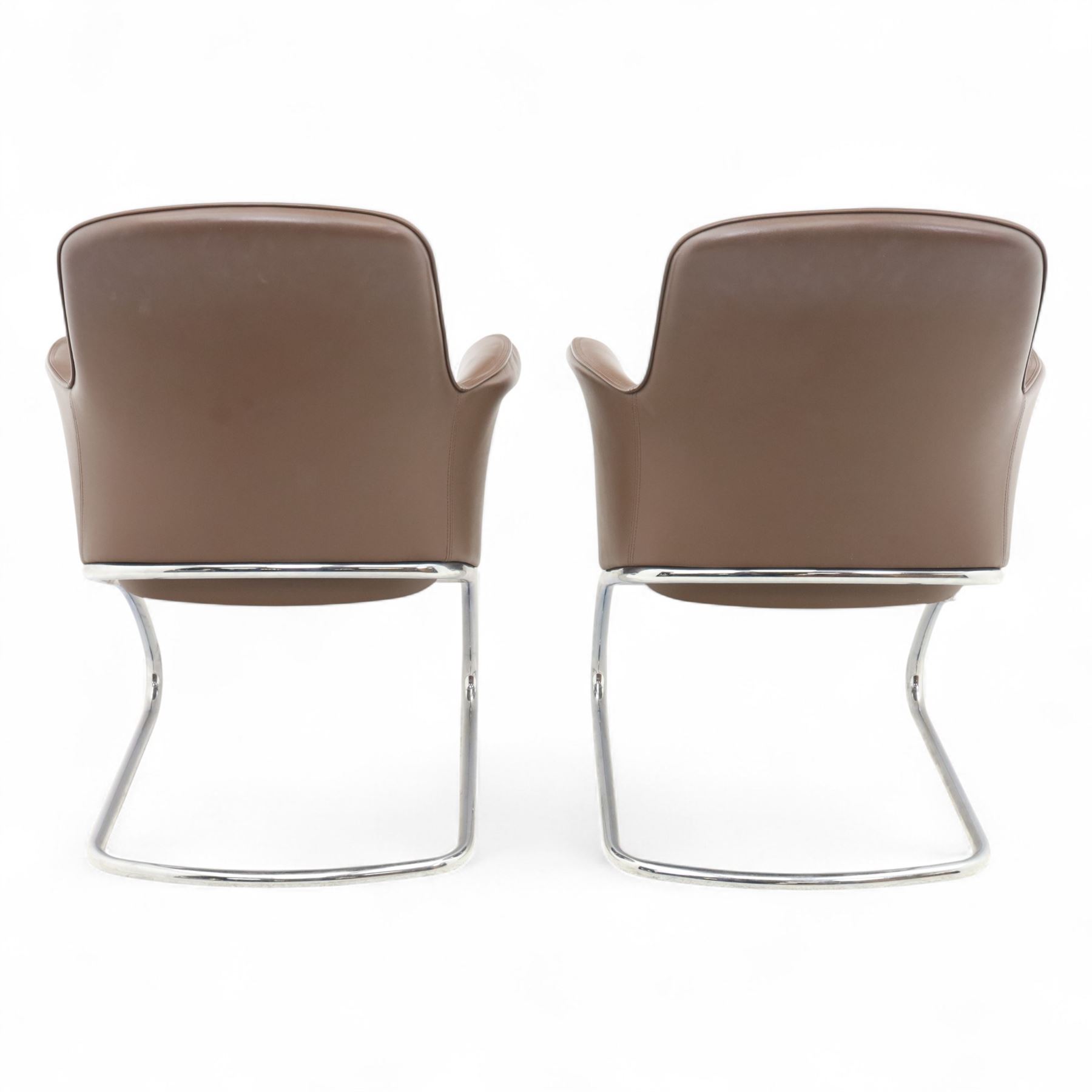 Four Senator executive cantilever chairs, upholstered in Padova hide, moulded back and integrated armrests, raised on a tubular chromed cantilever base