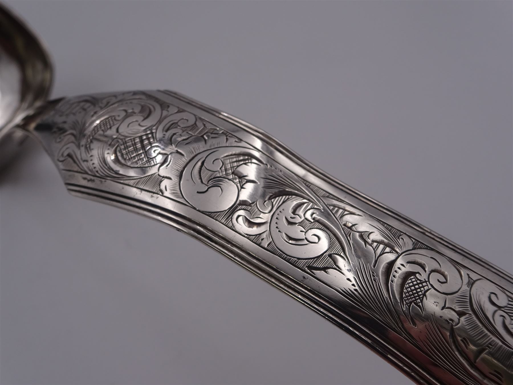 Mid 19th century Dutch silver 833 standard soup ladle, with rounded rectangular bowl, the shaped and curved stem engraved with foliate scrolls, marked with Lion Passant, Minerva Head with letter A for Amsterdam, date letter for 1847 and makers mark, approximate L30cm, approximate weight 4.52 ozt (140.6 grams)