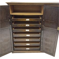 Early 20th century oak triple wardrobe, three panelled doors with geometric mouldings and fretwork spandrels, the interior fitted with slides and hanging rail