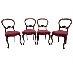 Set of six Victorian rosewood dining chairs, the balloon back carved with foliage scrolls, cartouche carved middle rail with extending scrolls, the seats upholstered in pink fabric, on carved cabriole supports with scrolled terminals 