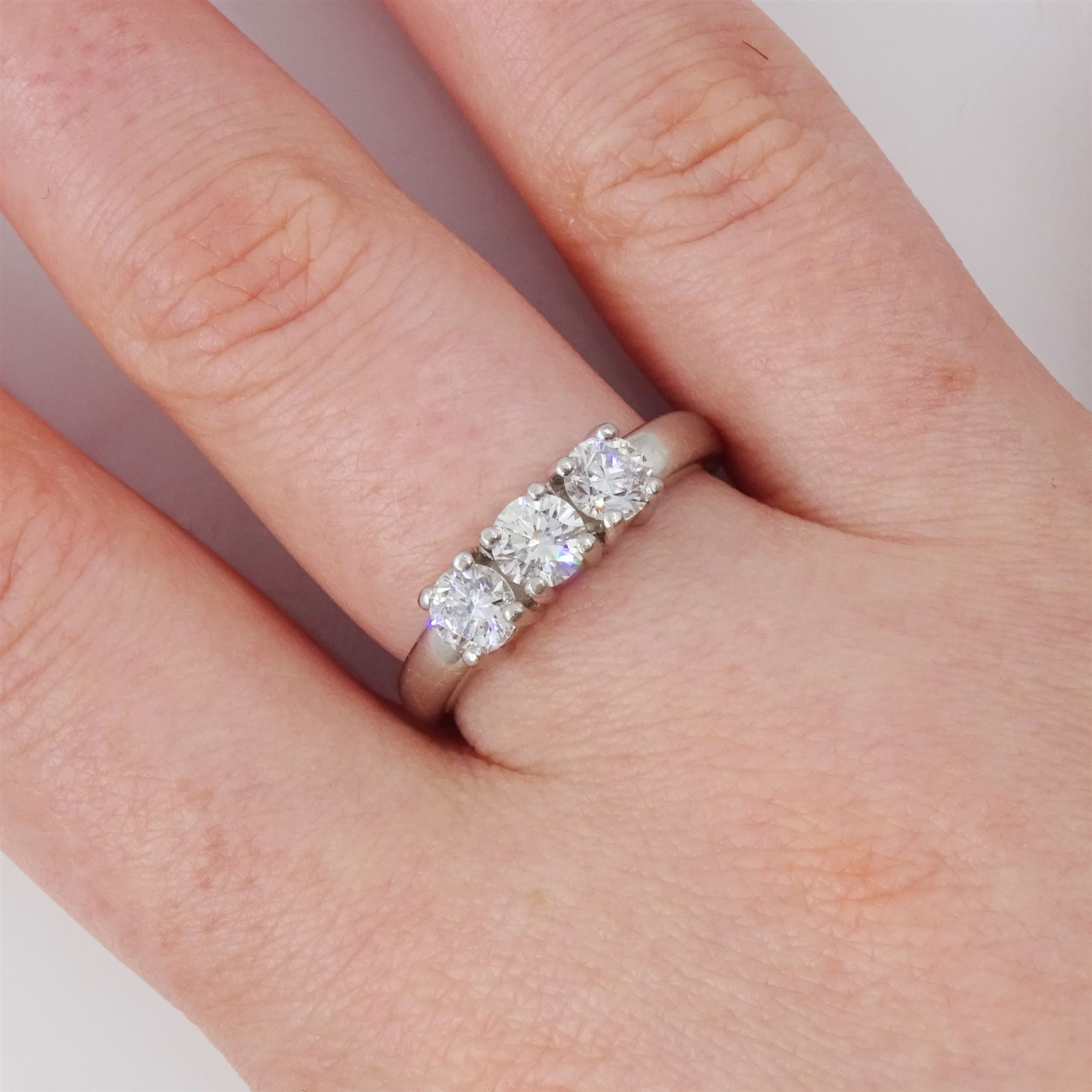 Platinum diamond three stone ring, each four claw set with a round brilliant cut diamond, hallmarked, total diamond weight approx 1.00 carat