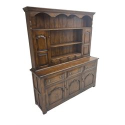 18th century design oak dresser, the projecting dentil cornice over two panelled cupboards, shelves and spice drawers, the base fitted with three drawers and three cupboards with pointed ogee fielded panels