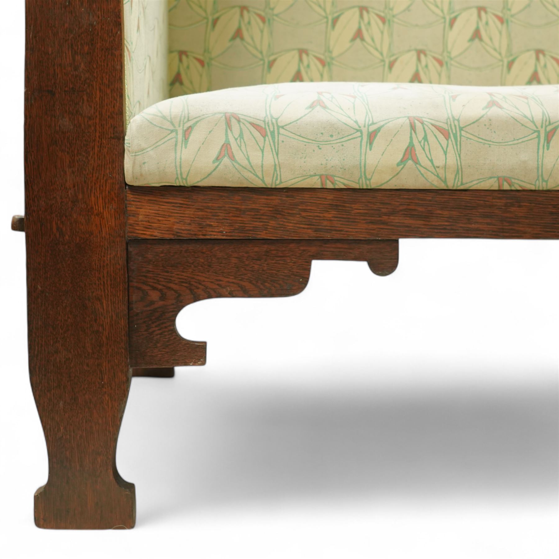 James Shoolbred & Co. (1814-1934) - Arts & Crafts high-back oak settle or hall-bench, the projecting cresting rail over a frieze decorated with stylised poppy pewter inlays, the drop-in sprung seat beneath high back and arms, flanked by tapering uprights terminating to shaped stile feet, upholstered in Archibald Knox patterned fabric with the original tapestry and horsehair upholstery beneath, applied plaque by James Shoolbred to underside, with stamped serial number W1573, circa 1890