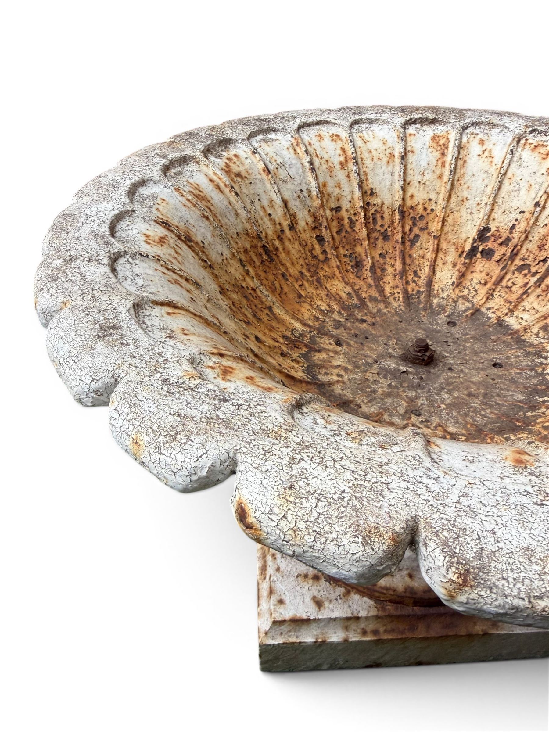 Coalbrookdale - pair of 19th century cast iron petal rim urns, squat form on square plinth, finished in distressed white paint, design registration number 133334, first registered 19 september 1860, number 19 in the Coalbrookdale Castings Catalogue (see illustration)