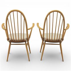 Ercol - elm dining chairs, set of six including two armchairs, arched spindle backs over shaped elm seats with upholstered pads, tapering beech legs joined by stretchers