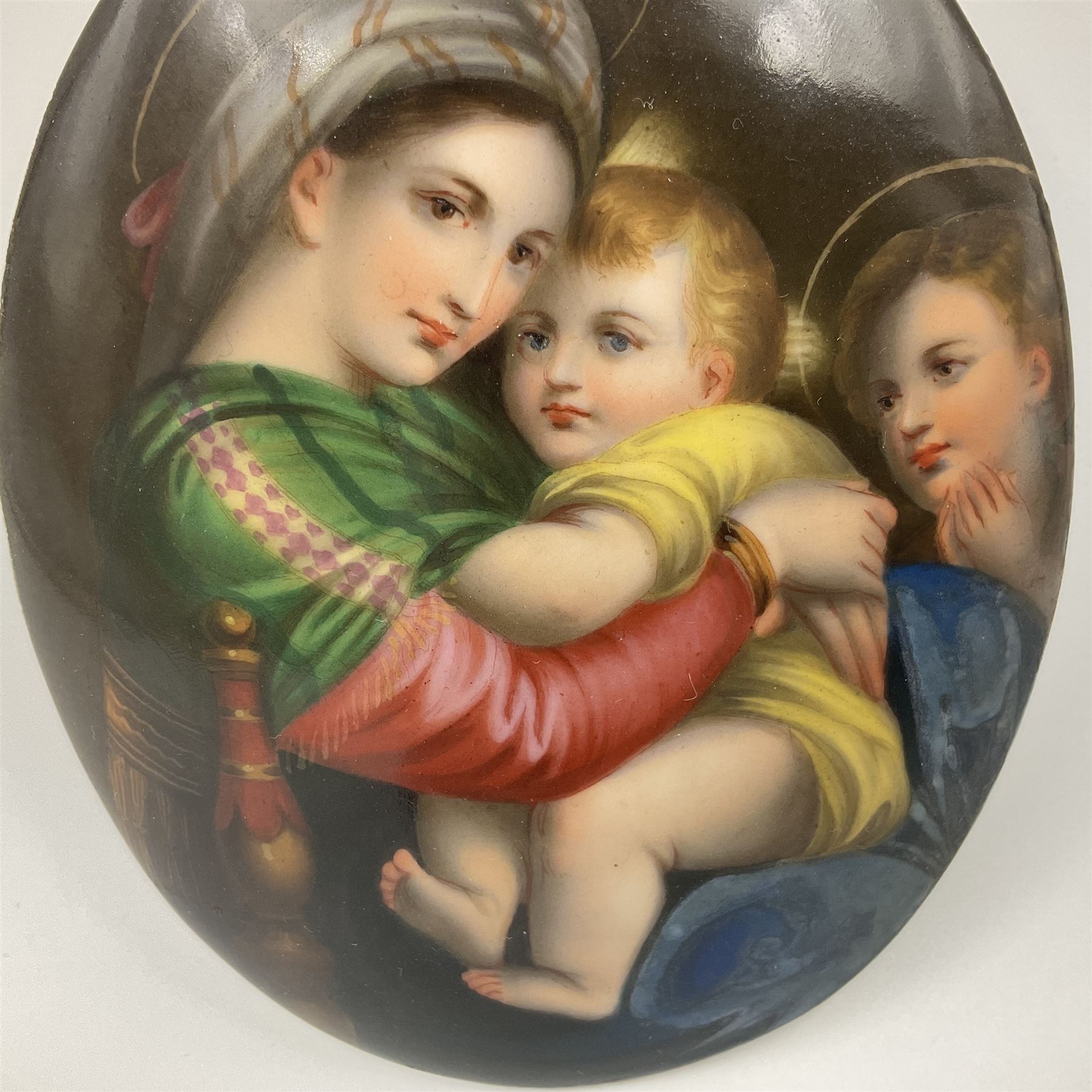 19th century Continental porcelain plaque, of oval form, painted with the Madonna and Child after Raphael, unmarked, possibly KPM, H12cm W9cm 