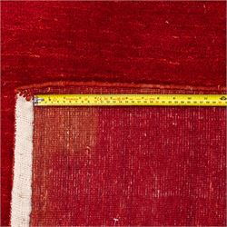 Indian hand-knotted wool Gebbeh design carpet, of rectangular form, woven in a rich madder red tone