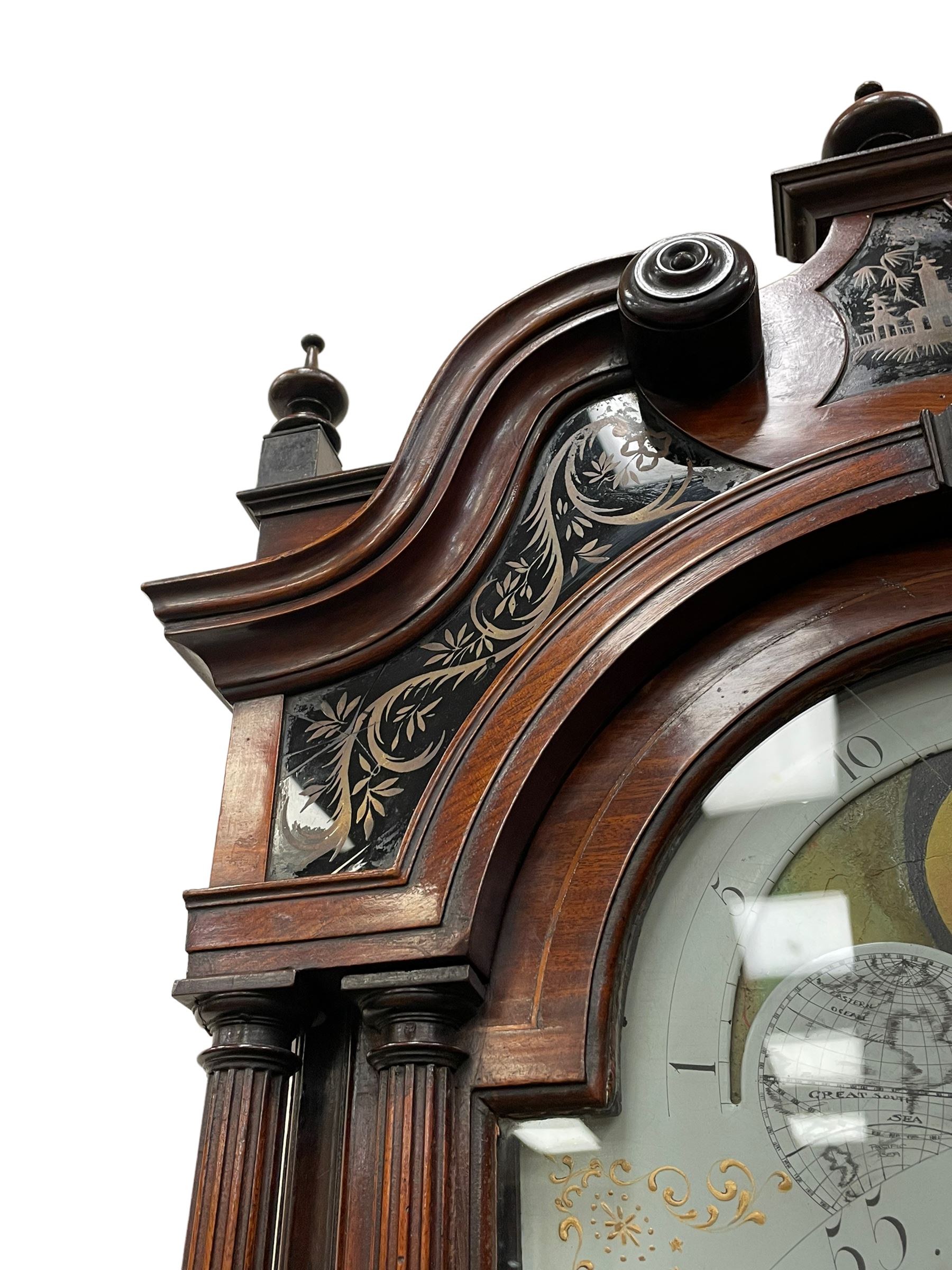 Penlington of Liverpool – early 19th century 8-day mahogany longcase clock, swans neck pediment with three turned wooden finials and verre eglomise panels, trunk with reeded columns and wavy topped door, plinth with canted corners on bracket feet, painted break-arch dial with Roman numerals and five-minute Arabic’s, centre sweep calendar and seconds hands, blue steel serpentine hands, signed beneath a painted rolling moon in the arch PENLINGTON, LIVERPOOL, eight day four pillar movement, anchor escapement and rack striking on a bell. With pendulum and weights.  The Penlington family were prolific clockmakers in 19th century Liverpool working from several addresses in the city, also recorded as chronometer and chronograph makers.