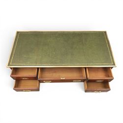 Military campaign style mahogany writing desk, inset gilt-tooled green leather writing surface, fitted with five drawers with recessed brass handles, brass corner mounts and protective bindings, on square tapering legs
