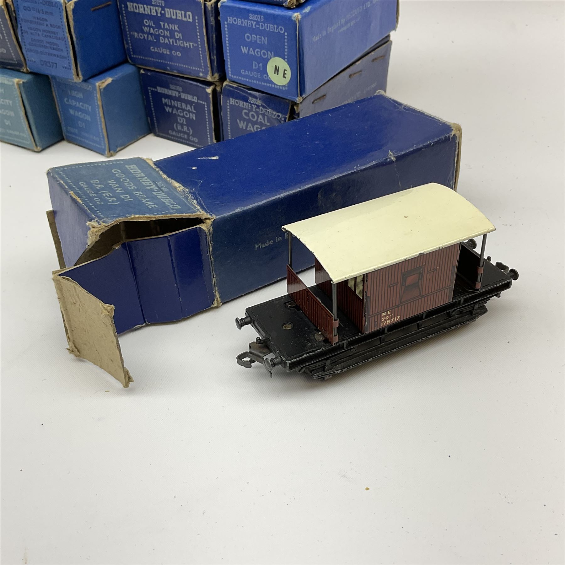 Hornby Dublo - thirteen D1/D2 wagons comprising Oil Tank Wagon 'Royal Daylight'; Coal Wagon; Fish Van; Mineral Wagon; two High Capacity Wagons; two Bogie Bolster Wagons; two Goods Brake Vans (one LMS and one BR/ER); two Open Wagons (one NE); and Cattle Truck; all in medium or dark blue boxes (13)