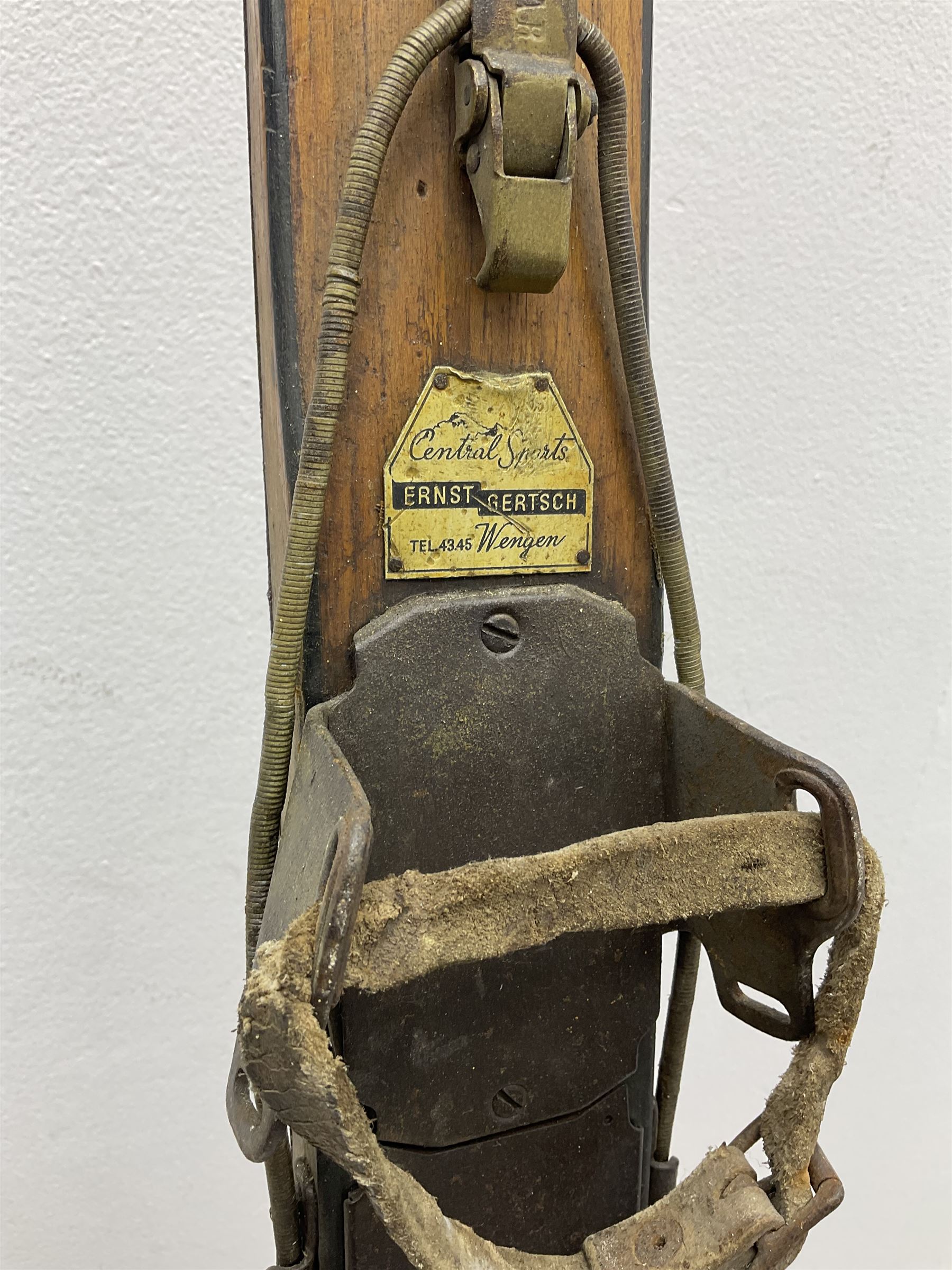 Pair of 1930s wooden skis, with painted metal runners beneath stamped Attenhofer, with retailers label for Ernst Gertsch Central Sports, L206cm