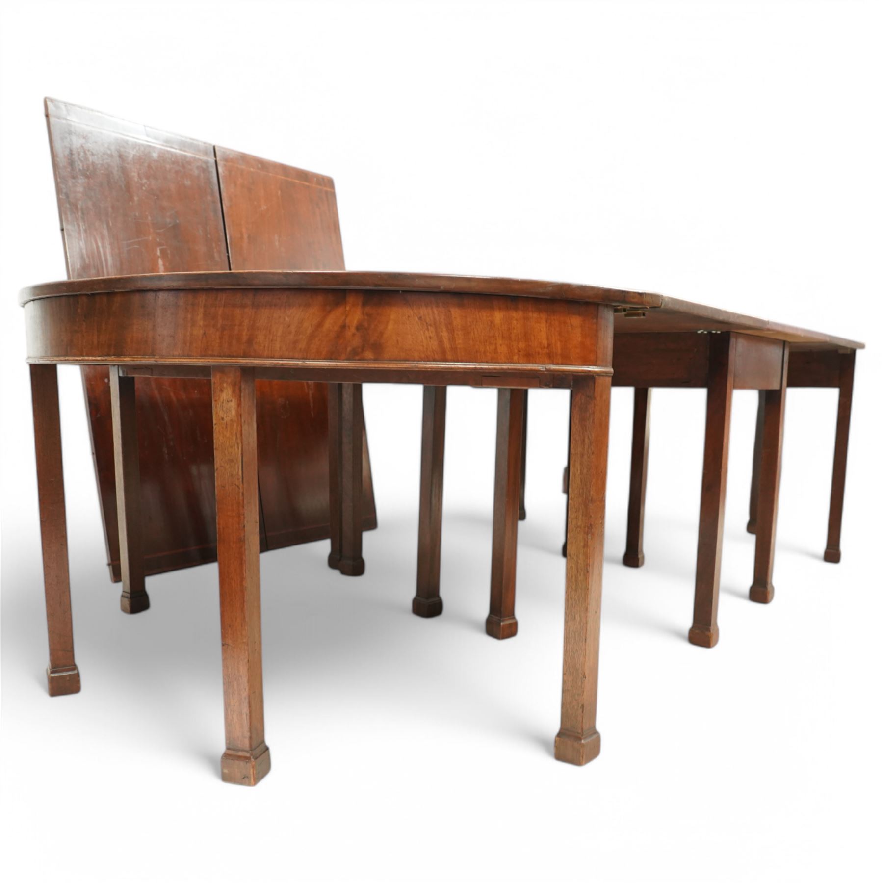 19th century and later mahogany extending dining table (12' 7’'), two D-ends, central drop-leaf table and two additional leaves, with satinwood bands, on square supports with block feet (lacking forks)