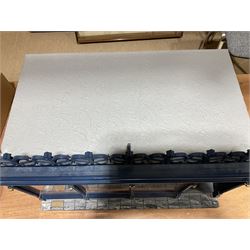 Good quality late 20th century dolls house by M. James dated 1995 in the form of a Beverley East Yorkshire Antique Shop called 'North Bar Antiques'; single-storey single-roomed shop with textured brick walls and flat roof, fully glazed hinged front with recessed hinged customer door and central window to the rear; comprehensively furnished with chests of drawers, pedestal desk, breakfast table, lowboy, two longcase clocks, delft rack with ceramics, occasional tables, pictures, Regency style mirror and collectibles; decorated walls with coving and picture rail and simulated floorboarding; wired for electric lighting; maker's plaque W61cm H42.5cm D41.5cm