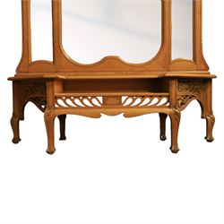 Art Nouveau oak hall mirror, the scrolling frame with large central bevelled mirror plate, boardered by six small mirrors with four shelves between, the base, with carved and pierced floral decoration, upon six cabriole legs   