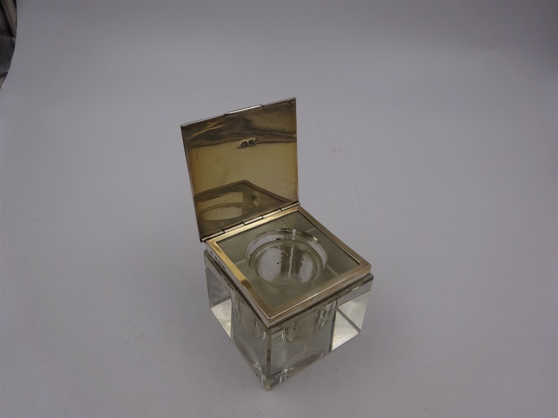 1930s silver mounted glass inkwell, of square form, the silver lid with engine turned decoration and engraved initials, hallmarked Adie Brothers Ltd, Birmingham 1937, H4.7cm