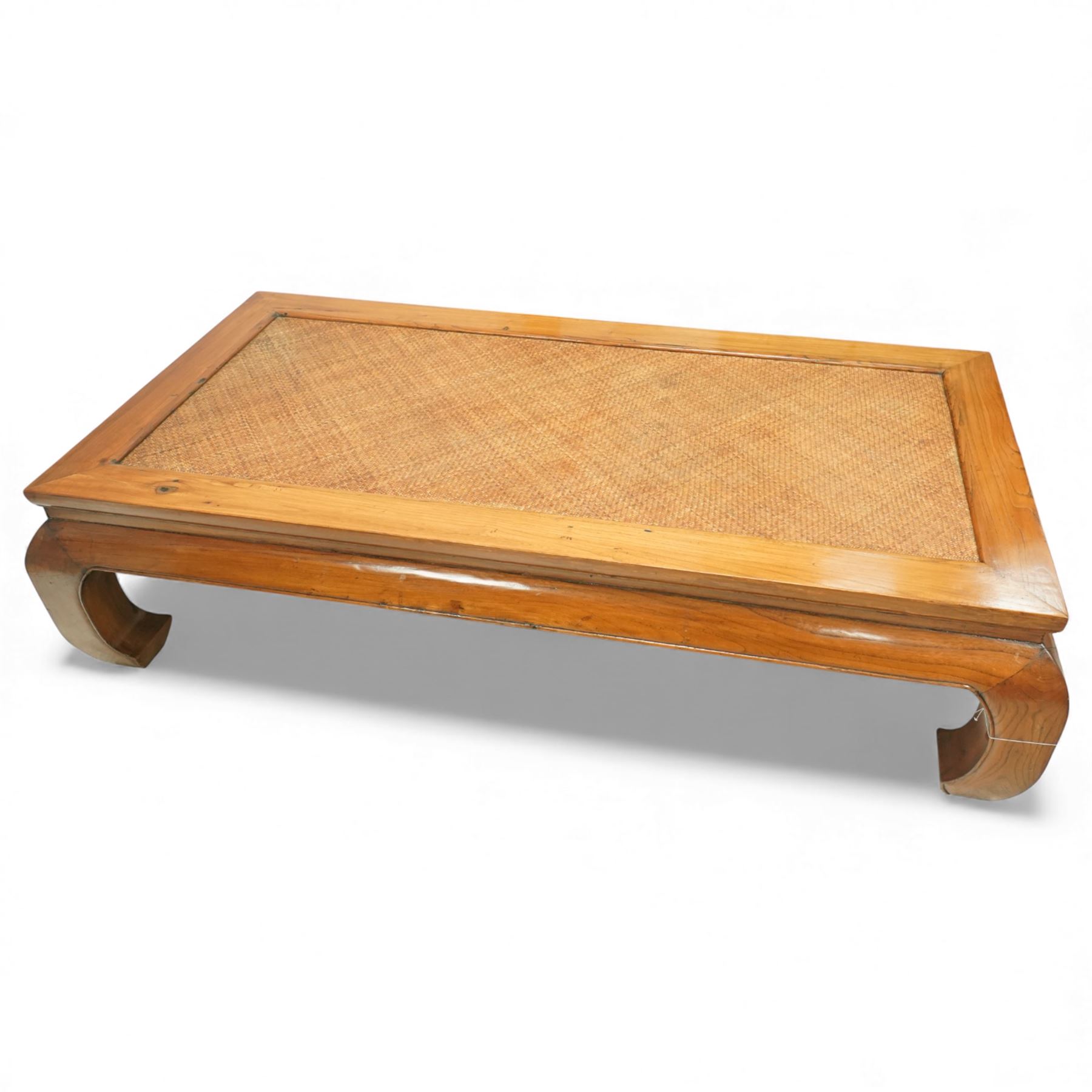 Chinese hardwood low coffee table, rectangular framed top inset with woven cane panel, mitred moulded edge, plain apron, raised on shaped and out-scrolled end supports joined by stretchers