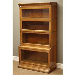  Early 20th century oak 'Gunn' graduating four sectional library bookcase with glazed hinged doors, W87cm, H158cm, D42cm  