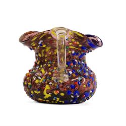 Two Murano Glass jugs by Zecchin, the fist decorated with millefiori design, upon a purple mottled ground, the other upon a green ground, H10cm