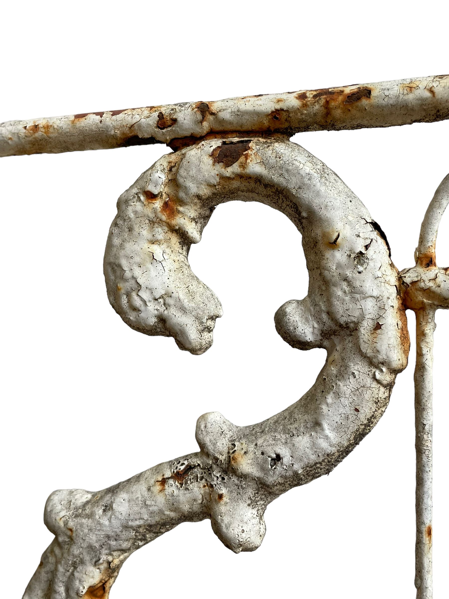 Regency design wrought metal garden bench, central lyre back with foliate S-scrolls with serpent masks, flanked by two floral mouldings and further scrolling, metal slatted seat on straight supports joined by H-stretcher  - THIS LOT IS TO BE COLLECTED BY APPOINTMENT FROM DUGGLEBY STORAGE, GREAT HILL, EASTFIELD, SCARBOROUGH, YO11 3TX