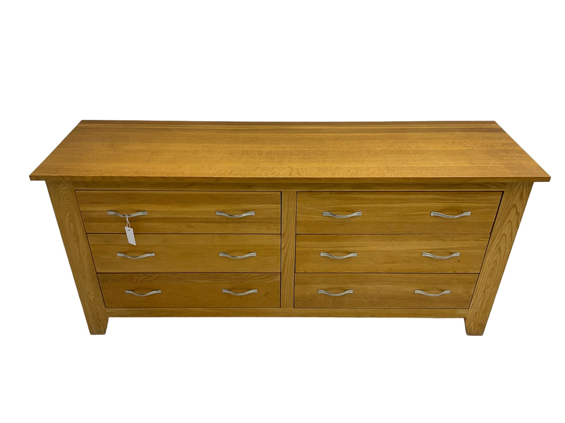 Contemporary wide oak straight-front chest, fitted with a bank of six drawers with chrome handles, on tapered feet