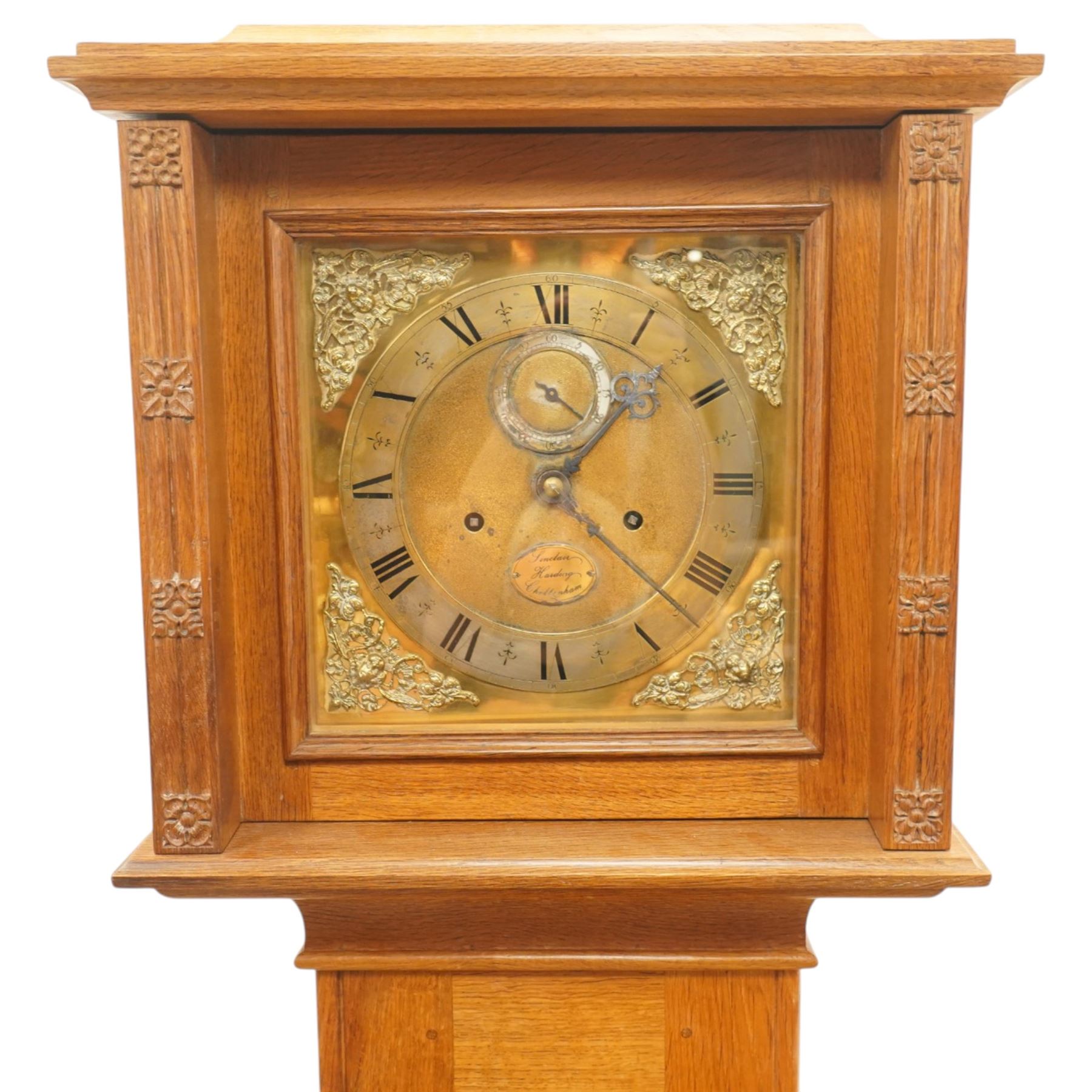 Mouseman - mid-20th century oak longcase clock, with a high quality weight driven movement and dial by Sinclair and Harding & Co of Cheltenham, the rectangular hood carved with foliate ornament, over a glazed and oak trunk on stepped base, with carved mouse signature, by the workshop of Robert Thompson of Kilburn Provenance: purchased directly from the Kilburn workshop in the 1940s/1950s