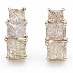 Pair of 18ct white gold diamond earrings, each stud set with three graduating princess cut...