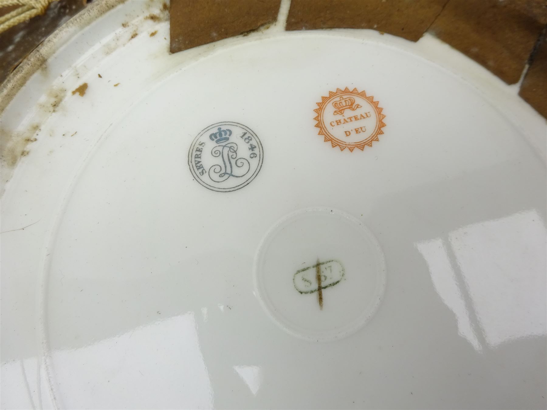 Pair mid 19th century Sevres porcelain plates, with gilt Louis Phillippe crowned monogram to centre upon a white glazed ground, with blue crowned LP mark, iron red destination mark for Chateau D'Eu, and chrome green cancelled potting mark S67 beneath, in carved oak mounts, overall D34cm
     