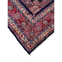 Persian Hamadan indigo ground carpet, the field decorated with central rectangle and outer band, overall floral pattern with cusped central medallion and surrounding leafy branches with palmettes, the border with scrolling branches decorated with further palmettes, within floral pattern guard stripes