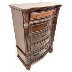 Kevin Charles American walnut serpentine chest, five graduating drawers, half turned fluted column carving, turned supports 