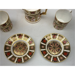 A pair of Royal Crown Derby Imari 1128 coffee cans and saucers, together with a Royal Crown Derby Imari 1128 loving cup, each with marks beneath. 