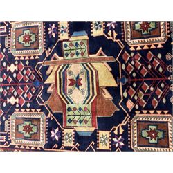 North West Persian Heriz Kelleh rug, the blue ground field with large stylised plant medallions, decorated with flower head, bird and tree of life motifs, triple band foliate pattern borders 